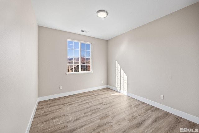 spare room featuring light hardwood / wood-style floors