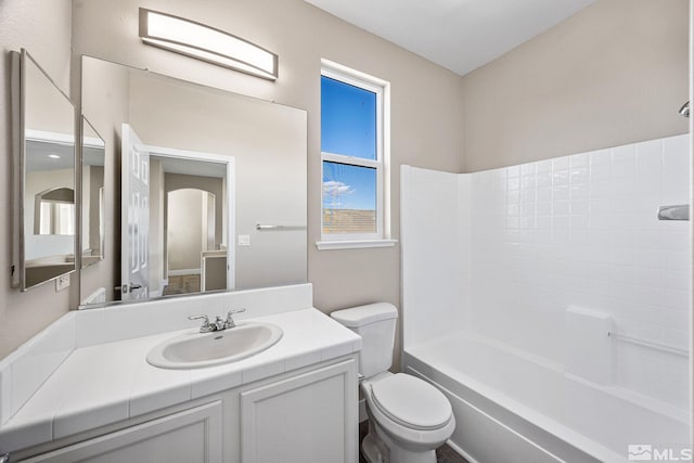 full bathroom featuring vanity, bathing tub / shower combination, and toilet