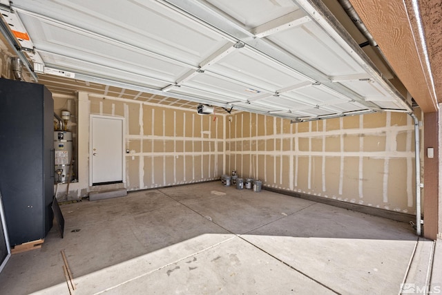 garage with a garage door opener and secured water heater