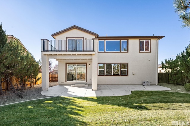 back of house featuring a patio, a yard, and a balcony