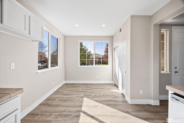 unfurnished dining area featuring light hardwood / wood-style floors