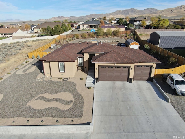 view of front of property with a mountain view and a garage