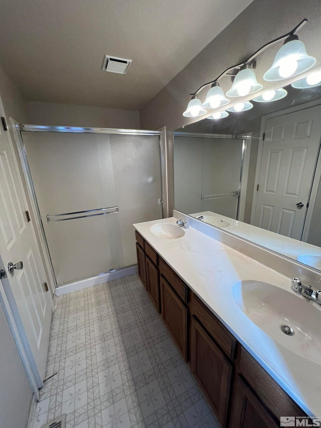 bathroom featuring vanity and a shower with shower door