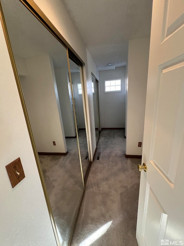 hallway with carpet floors