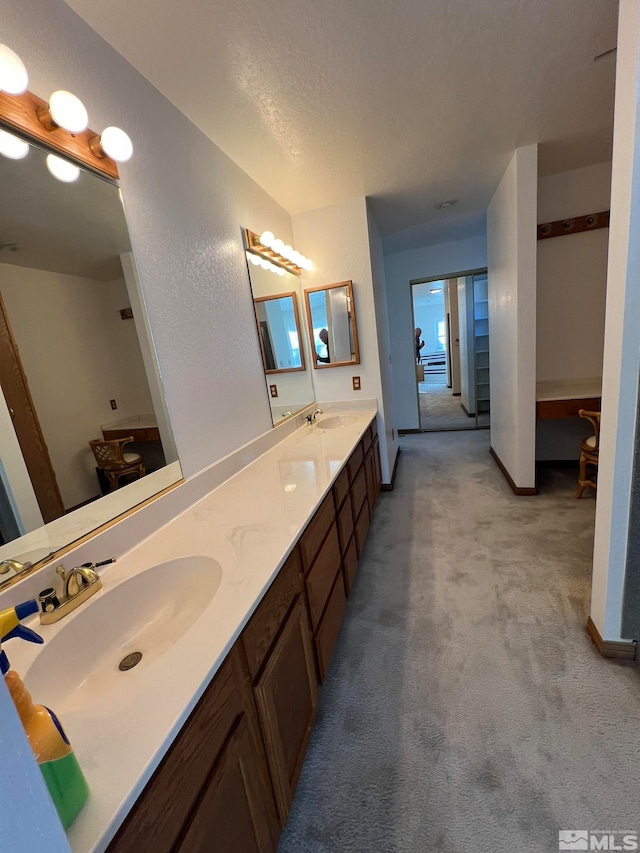 bathroom featuring a textured ceiling and vanity