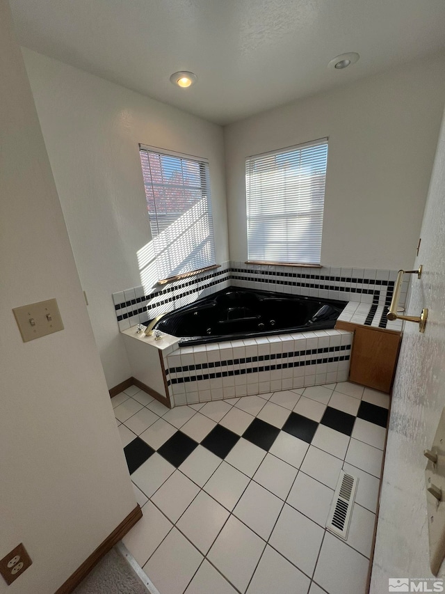 bathroom featuring tile patterned floors and tiled bath