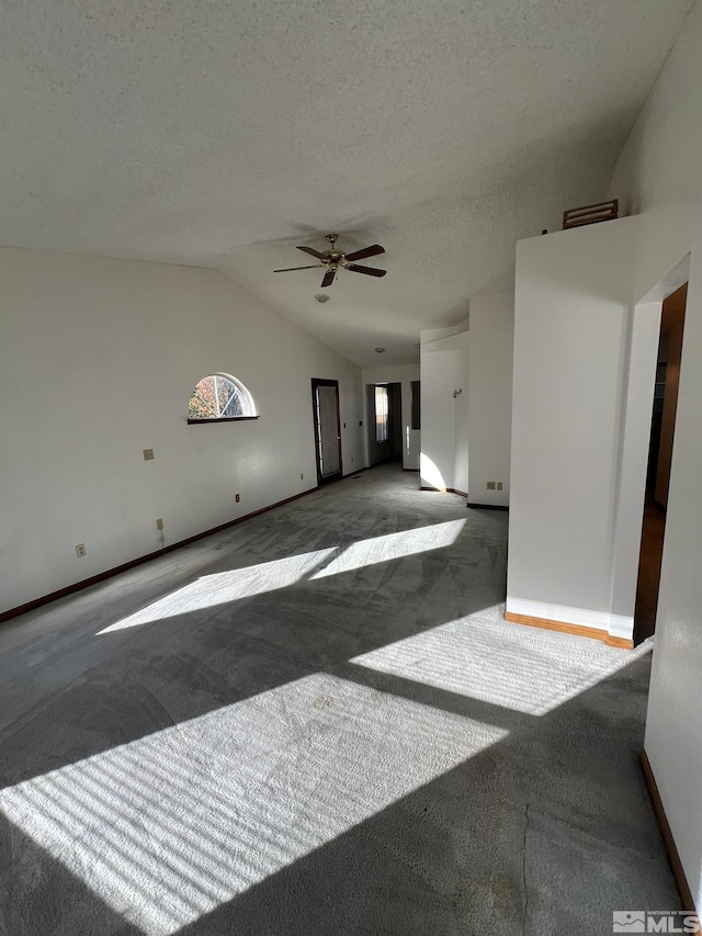 unfurnished living room featuring carpet flooring, ceiling fan, a textured ceiling, and lofted ceiling