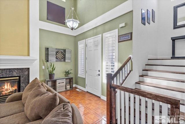 entrance foyer featuring tile patterned floors and a high end fireplace