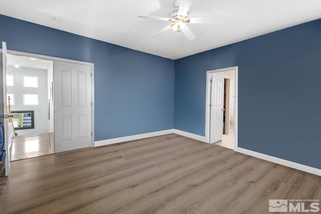 spare room with wood-type flooring and ceiling fan