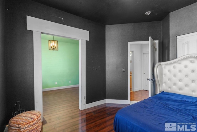 bedroom with hardwood / wood-style flooring