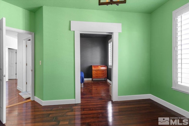 bedroom with dark hardwood / wood-style floors