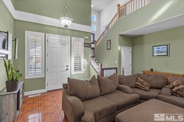 living room with tile patterned flooring and a healthy amount of sunlight