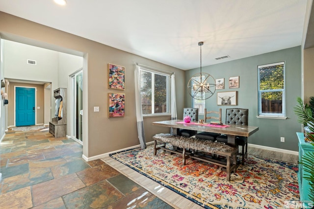 dining room featuring a notable chandelier and a healthy amount of sunlight