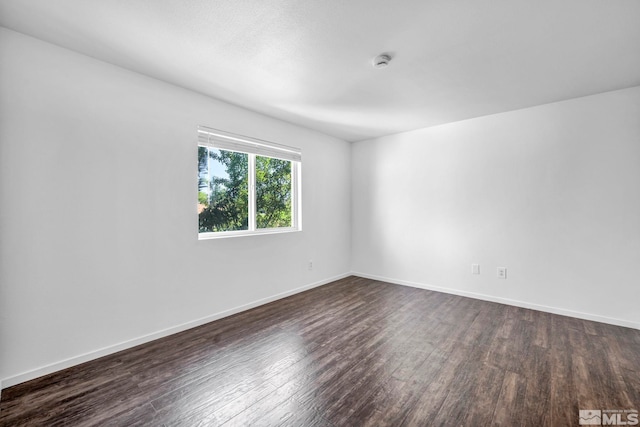 unfurnished room with dark hardwood / wood-style floors