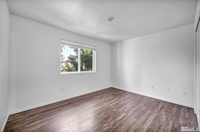 spare room featuring dark hardwood / wood-style flooring