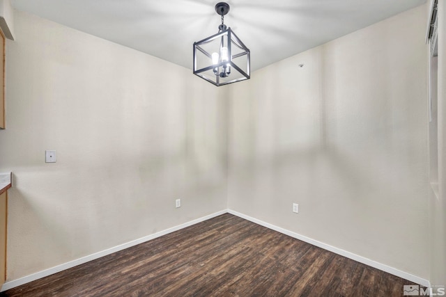 interior space featuring dark wood-type flooring and a notable chandelier