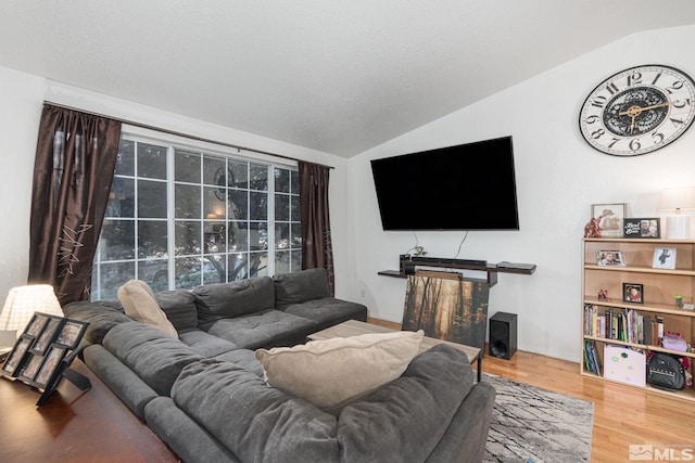 living room with hardwood / wood-style floors and vaulted ceiling