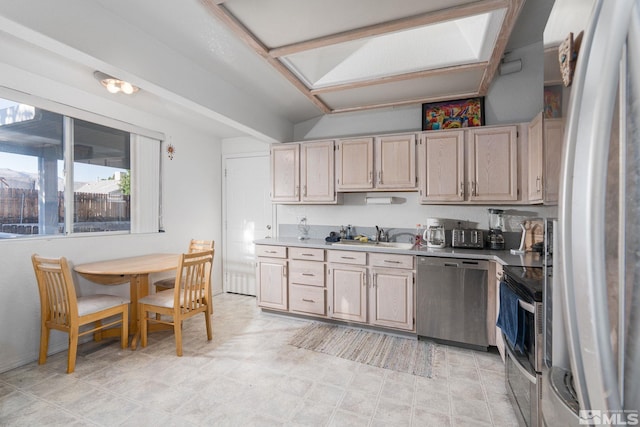 kitchen with light brown cabinets, appliances with stainless steel finishes, and sink