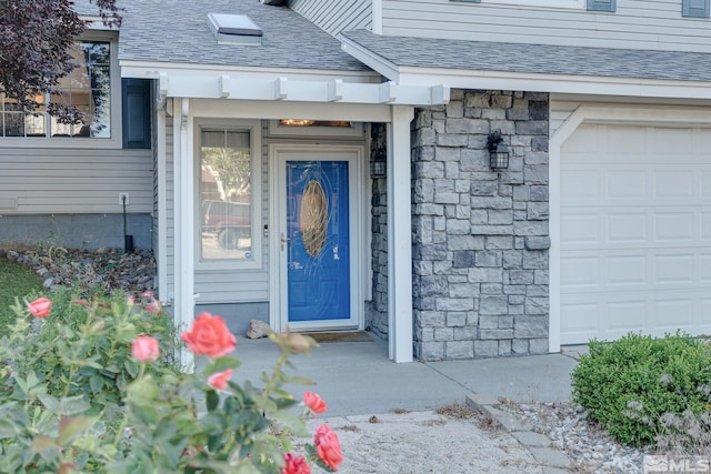 doorway to property with a garage