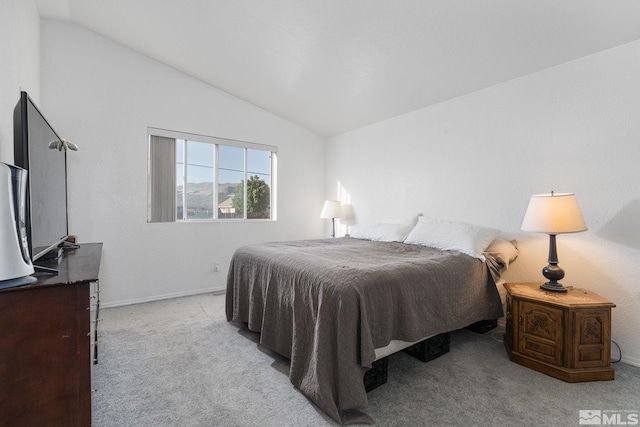 carpeted bedroom with lofted ceiling