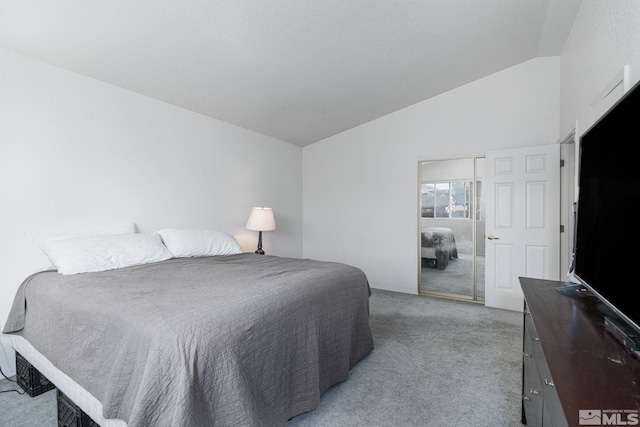 bedroom with lofted ceiling and light carpet