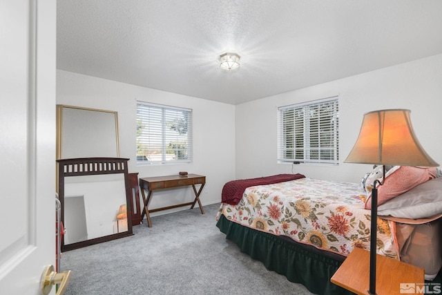 bedroom featuring a textured ceiling and carpet flooring