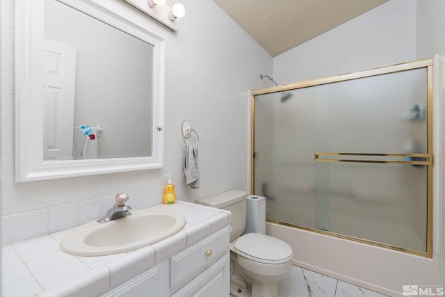 full bathroom with bath / shower combo with glass door, lofted ceiling, toilet, and vanity