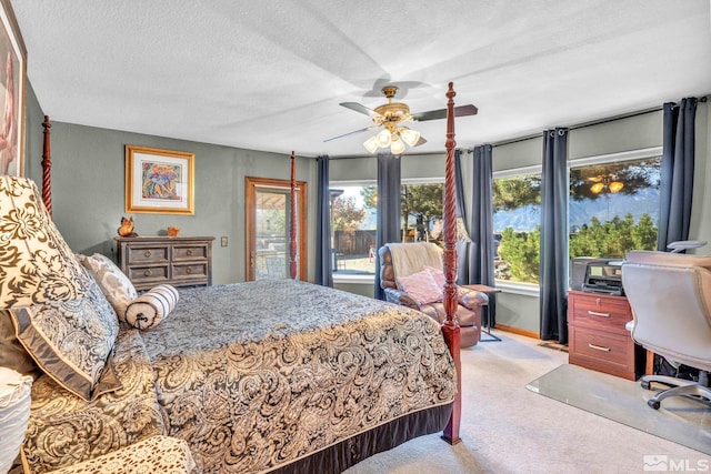 carpeted bedroom with a textured ceiling and ceiling fan