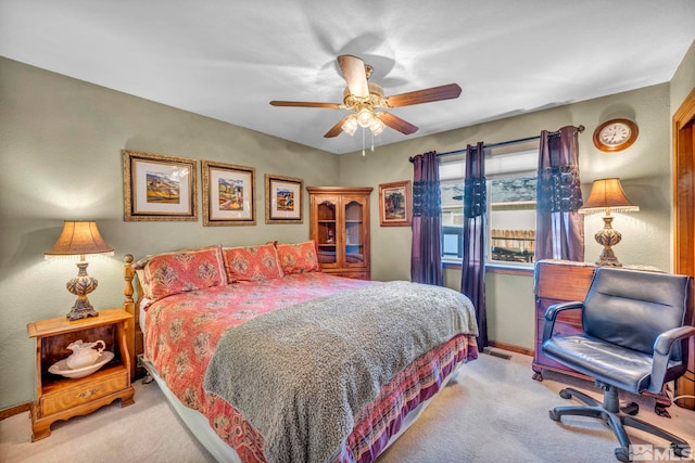 bedroom with ceiling fan and light colored carpet