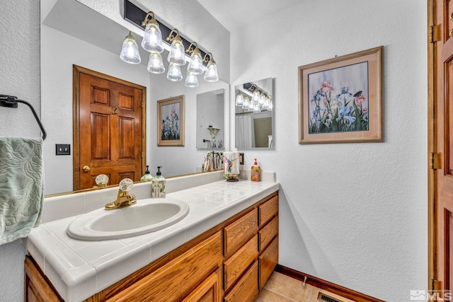 bathroom featuring tile patterned flooring and vanity