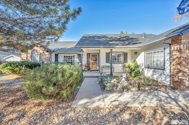 single story home featuring covered porch