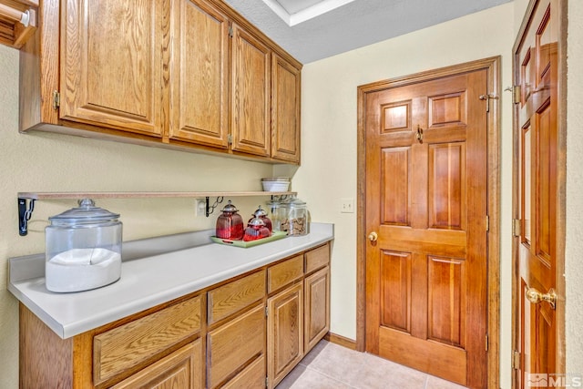 kitchen featuring a textured ceiling and light tile patterned floors