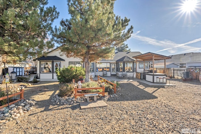 rear view of house featuring a sunroom and a patio area