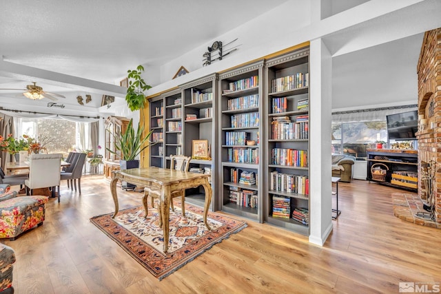 home office with hardwood / wood-style floors and ceiling fan