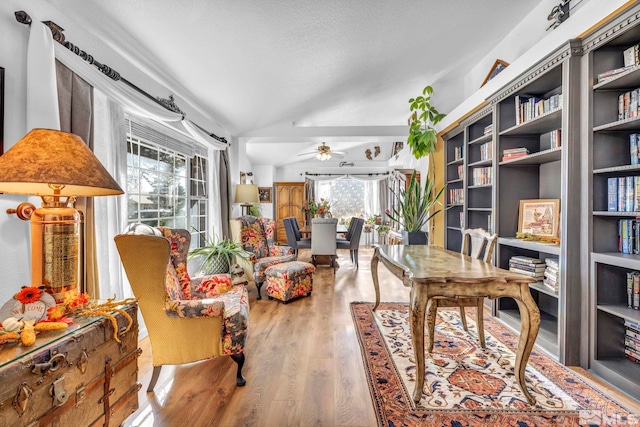 office with vaulted ceiling, hardwood / wood-style flooring, ceiling fan, and plenty of natural light