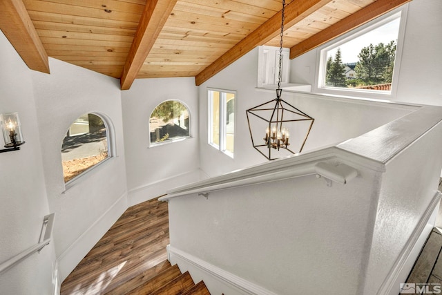 staircase with lofted ceiling with beams, a chandelier, hardwood / wood-style flooring, and wooden ceiling