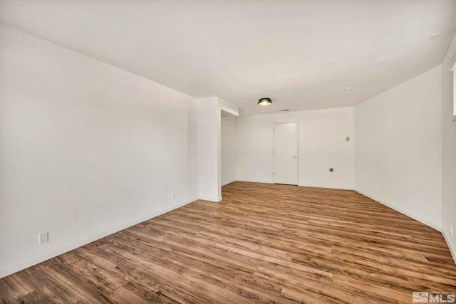 empty room with light hardwood / wood-style flooring