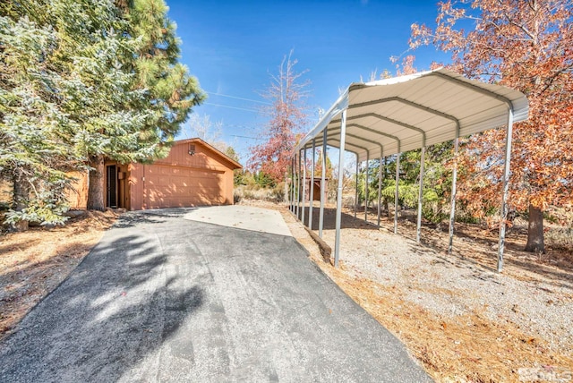 exterior space with a garage and a carport