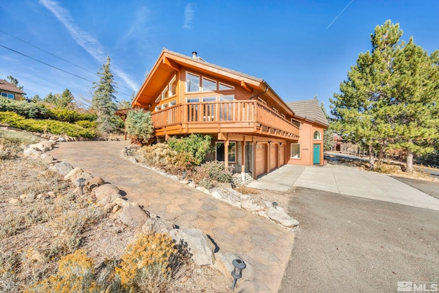 view of front of home featuring a garage and a deck