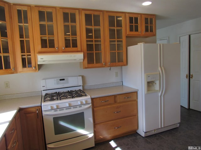 kitchen with dark tile patterned flooring and white appliances