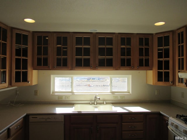 kitchen with white appliances, a healthy amount of sunlight, and sink