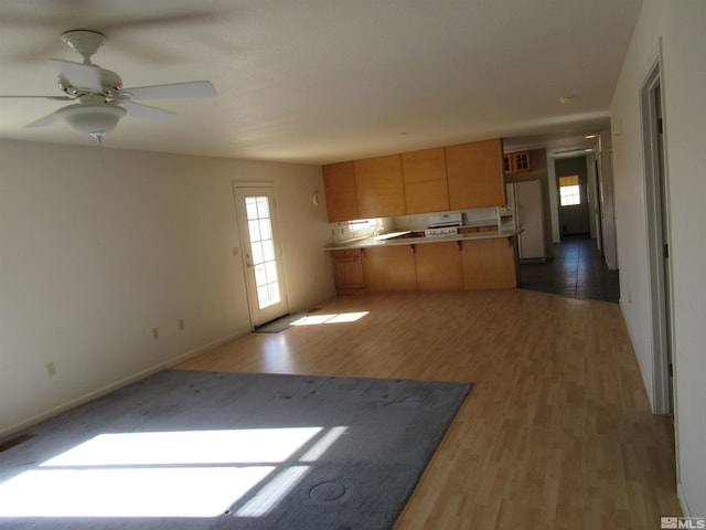 kitchen with ceiling fan, light wood-type flooring, and white refrigerator with ice dispenser