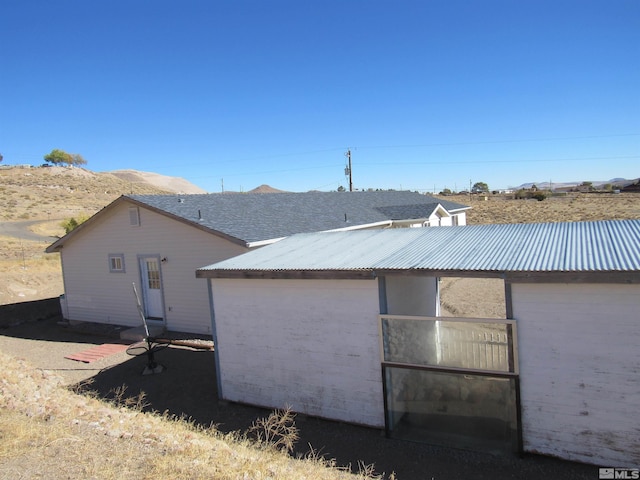 back of property featuring a mountain view