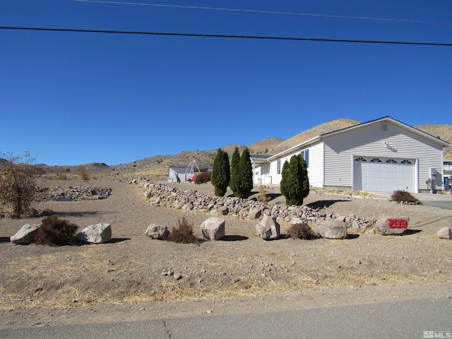 view of front of house featuring a garage and a mountain view