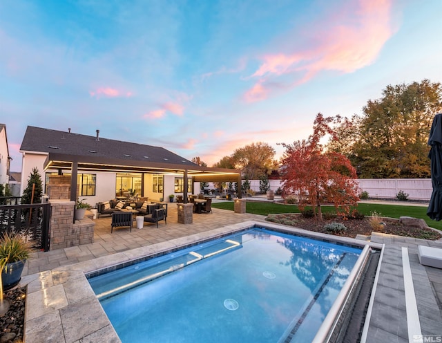 pool at dusk with an outdoor living space and a patio area