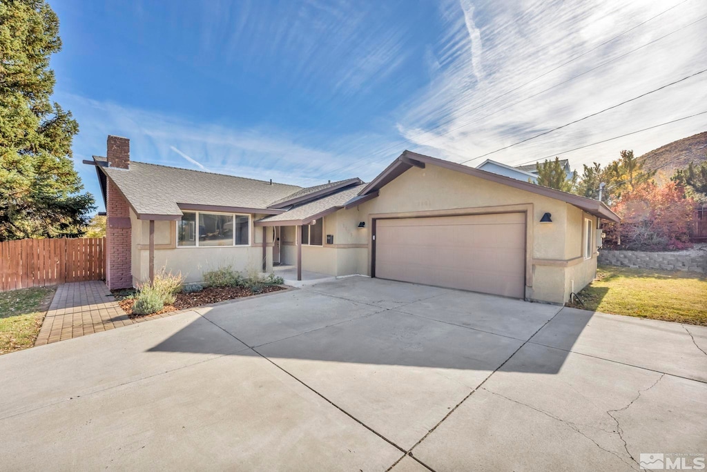 ranch-style home featuring a garage