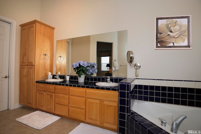 bathroom featuring tile patterned floors, vanity, and a relaxing tiled tub