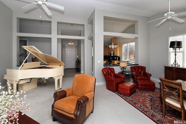 living room featuring carpet flooring, ceiling fan with notable chandelier, and high vaulted ceiling