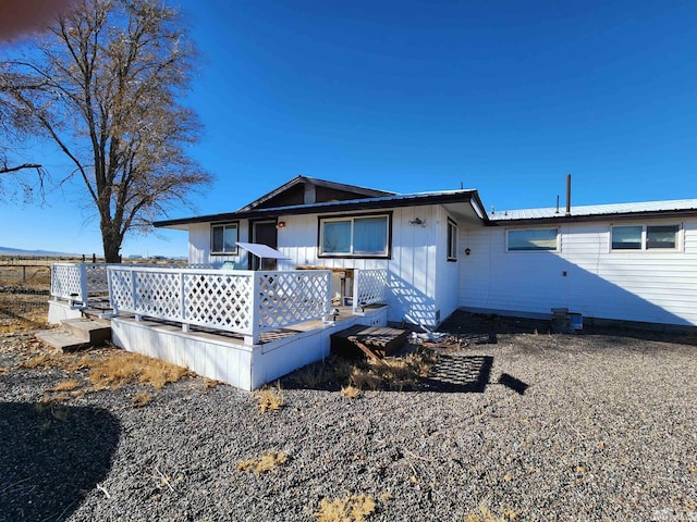 back of property featuring a wooden deck