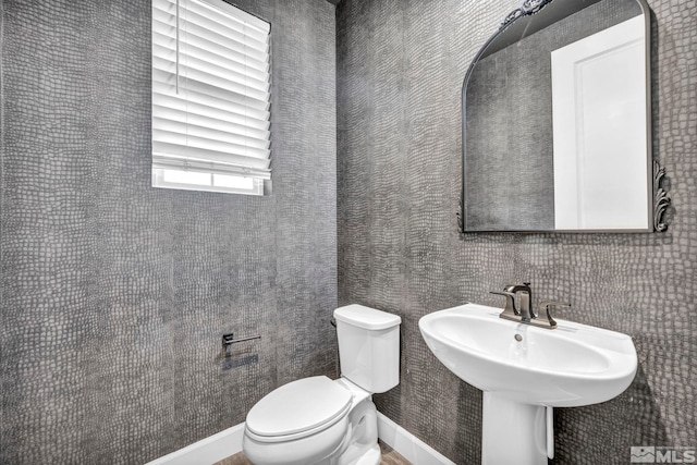 bathroom with toilet and sink